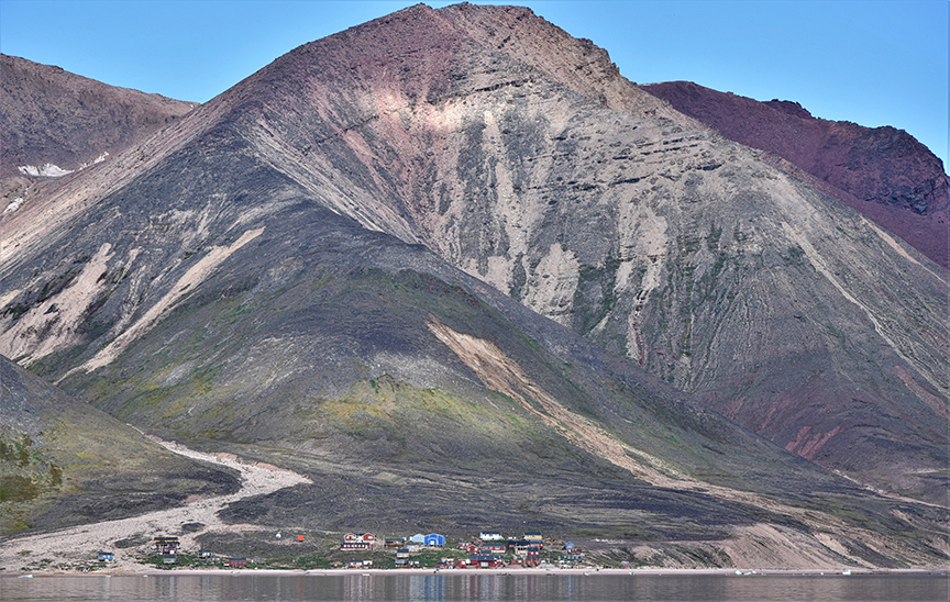 row of houses against arctic mountain