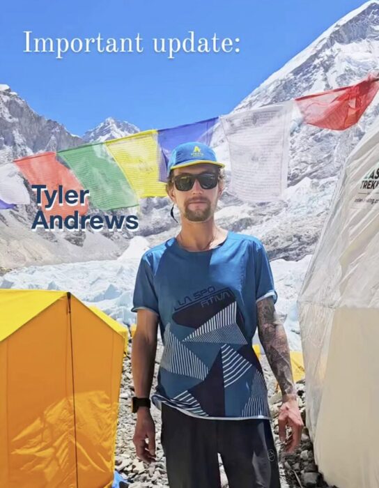 Tyler Andrews in a t-shirt and camp at Everest Base Camp.