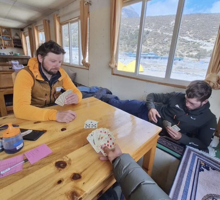 Climbers play cards at a lodge in Nepal.