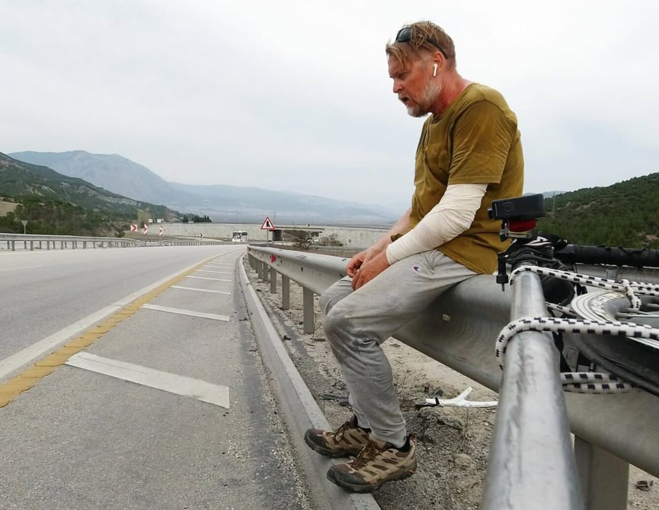 Karl Bushby sits on the side of the road in Turkey