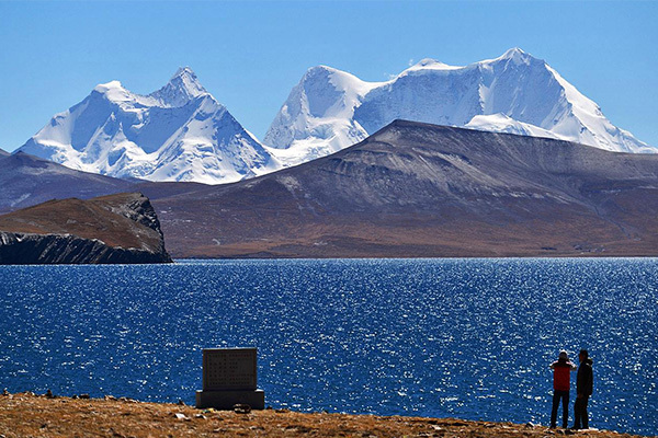 Impresive mountain massif seen from a placid lake.