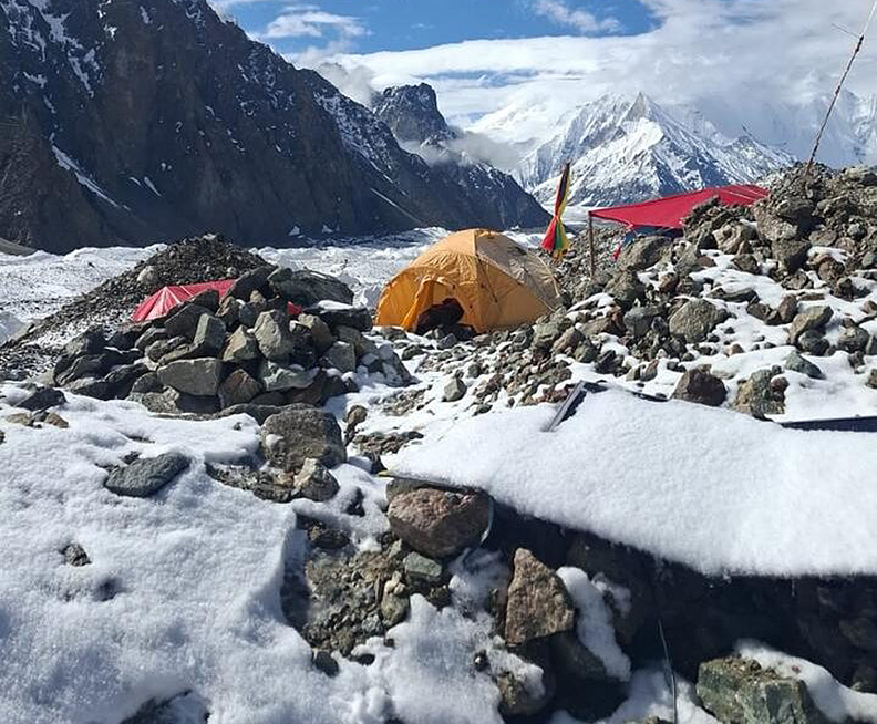 Some tents on a rock and ice glacier.