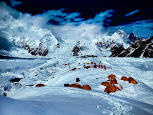 Gasherbrum BC in the night, with tents covered with some fresh snow under the moonlight.