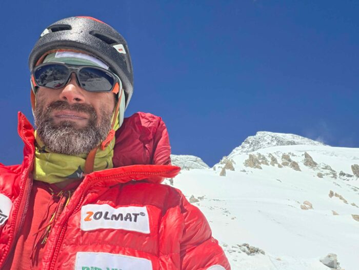 Close shot of David Klein witgh a snowy peak in brackground. 