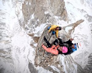 view from overhead of 3 climbers atop tower of rock