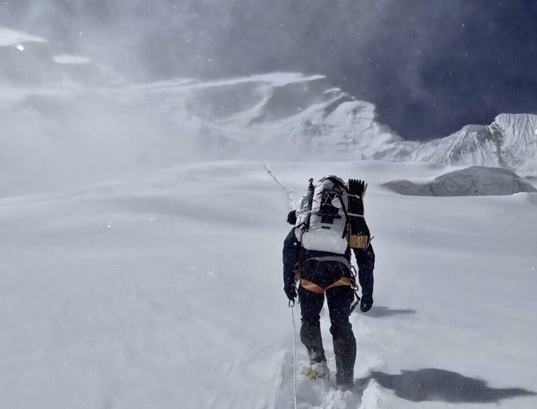 A climber moves in blustery winds toward Camp 2 on Annapurna I.
