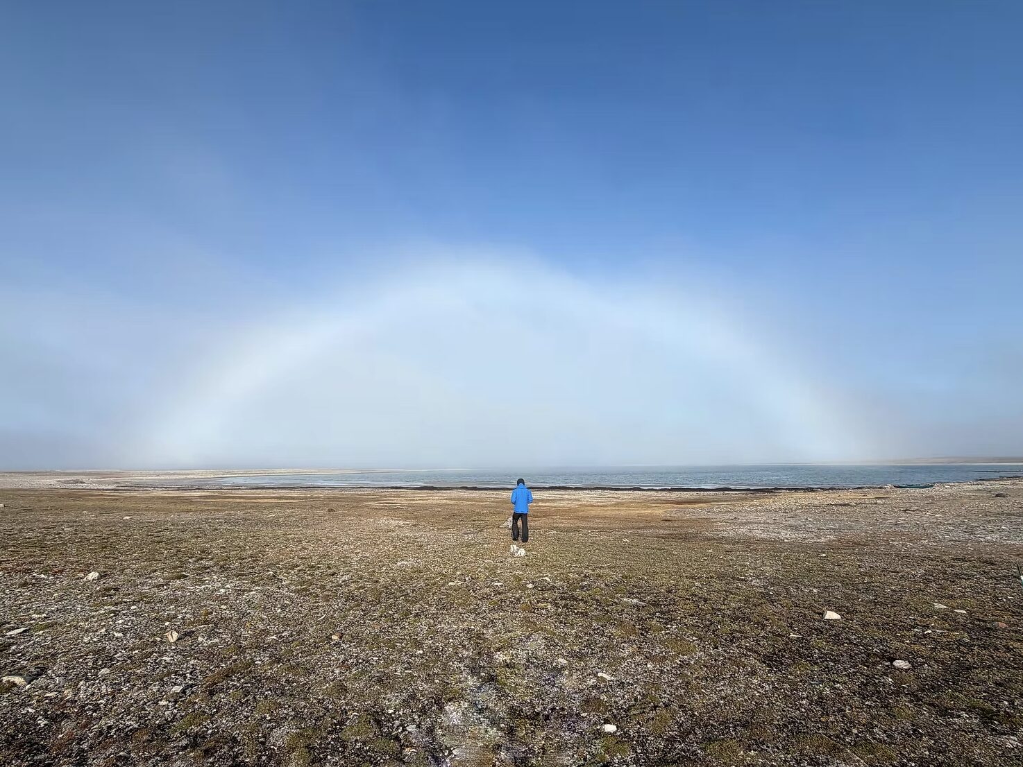 small person in middle of fogbow