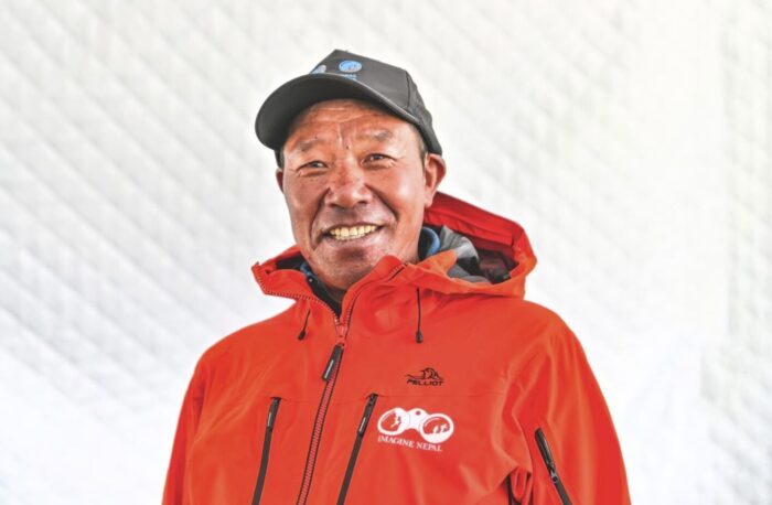 Close shot of Phur Galjen Sherpa with a red gore-tex jacket wih Imagine Nepal logo embroided. 