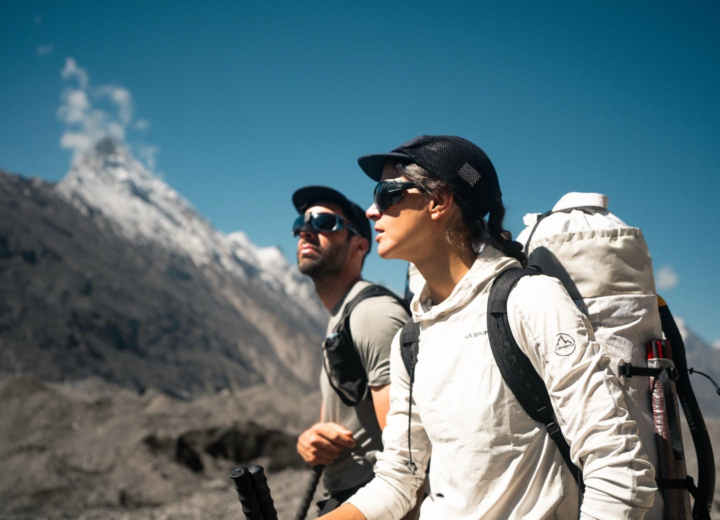Close shot of the italian climbing couple Ragazzo and Loreggian in sunglasses and caps, at a mountain setting.