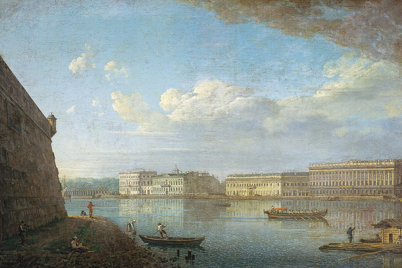 A cityscape with dockyard and large buildings in the distance