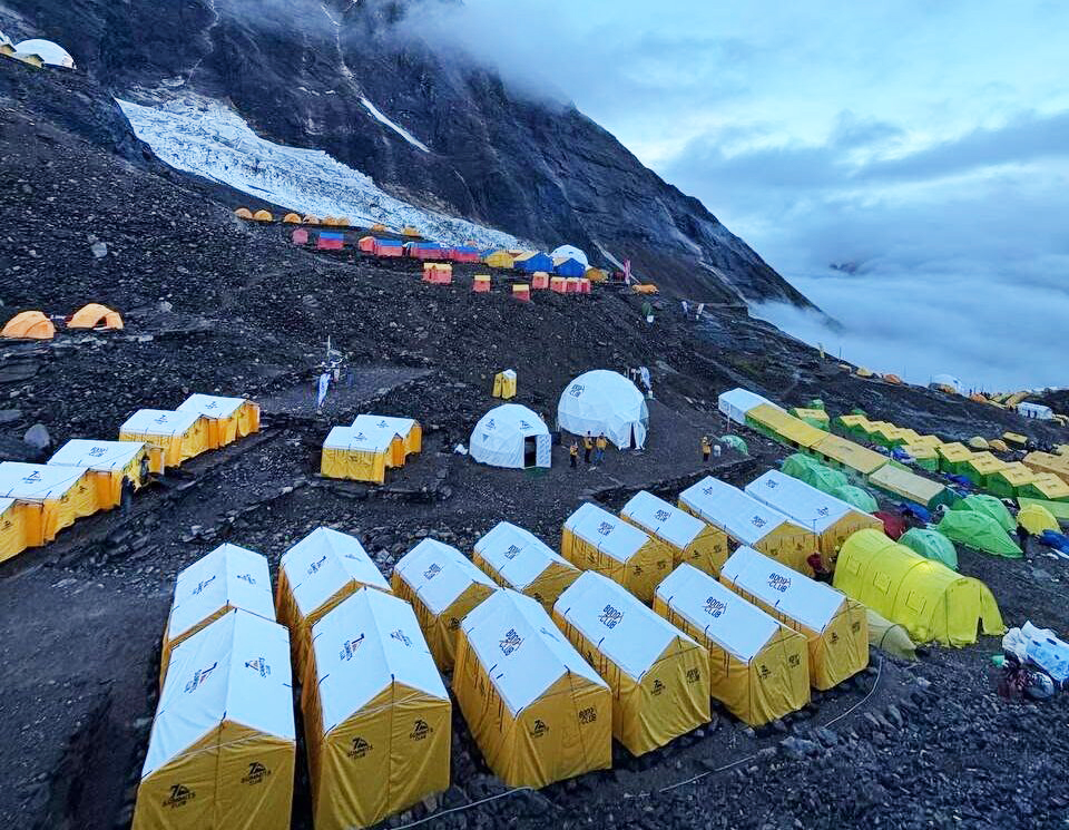 Tents on a dark moraine on a rainy day.