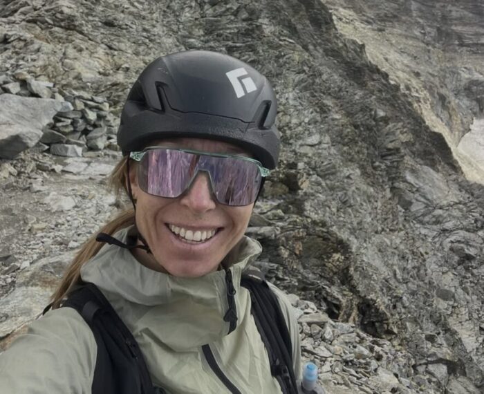 Selfie of Canadian trailrunner Kalie mcCrystal wuth suglasses and a helmet.