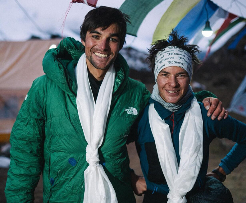 two smiling climbers