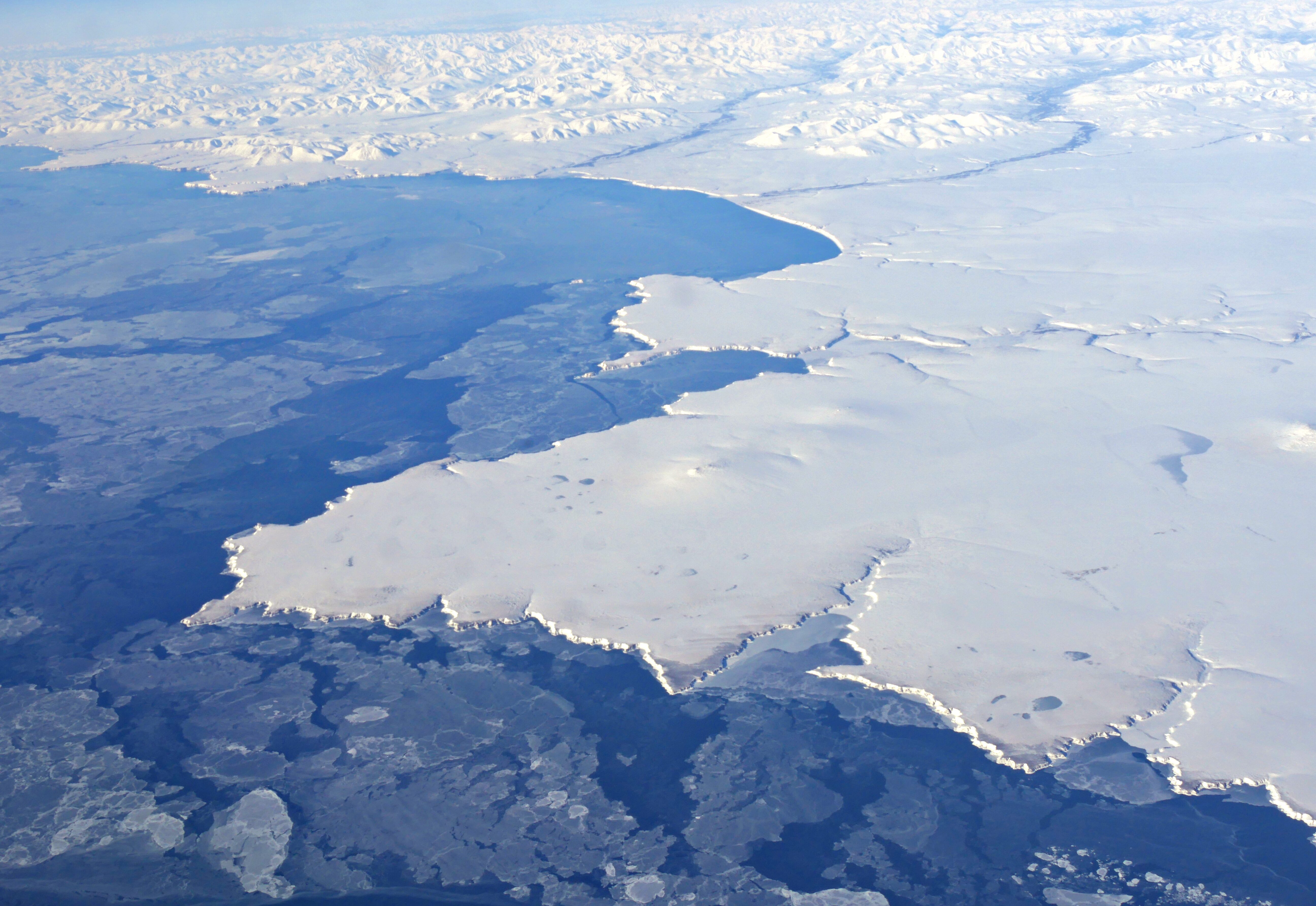 An aerial wide shot of an icy sea